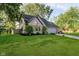 Lovely home with lush green lawn, mature trees, brick details, garage and an American flag in front at 410 Wood Hollow Ct, Westfield, IN 46074