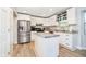 Well-lit kitchen with stainless steel appliances, granite countertops, and white cabinetry at 410 Wood Hollow Ct, Westfield, IN 46074