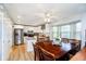Bright kitchen with white cabinets, stainless steel appliances, island, and hardwood floors at 410 Wood Hollow Ct, Westfield, IN 46074