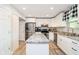 Bright kitchen with island, stainless steel appliances, white cabinets, and hardwood floors at 410 Wood Hollow Ct, Westfield, IN 46074