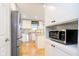 Kitchen view with microwave, stainless appliances, white cabinets, and granite counters at 410 Wood Hollow Ct, Westfield, IN 46074