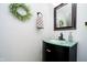 Stylish powder room with a modern glass bowl sink, dark wood cabinet, and decorative mirror at 410 Wood Hollow Ct, Westfield, IN 46074