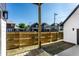 View from the back porch of the yard and fence showcasing neighborhood homes in the background at 43 N Walcott St, Indianapolis, IN 46201
