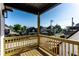 Balcony view showcases neighborhood homes under a clear blue sky; wooden rails and ample space at 43 N Walcott St, Indianapolis, IN 46201