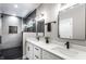 Modern bathroom featuring double sinks, white countertop, and glass-enclosed shower at 43 N Walcott St, Indianapolis, IN 46201