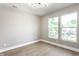Bright bedroom featuring hardwood floors and two windows providing ample natural light at 43 N Walcott St, Indianapolis, IN 46201