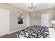Bedroom with two doors, hardwood flooring, neutral walls, and ample natural light at 43 N Walcott St, Indianapolis, IN 46201