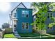 Modern home featuring a vibrant blue exterior, complemented by a well-manicured lawn and thoughtful landscaping at 43 N Walcott St, Indianapolis, IN 46201