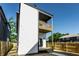 Exterior shot showcasing the deck off the back, white siding, a walkway, and partial fence at 43 N Walcott St, Indianapolis, IN 46201