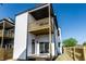 Exterior shot showcasing the deck off the back, white siding, and a clear, sunny day at 43 N Walcott St, Indianapolis, IN 46201