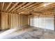 An unfinished garage interior with exposed wooden beams and a white garage door at 43 N Walcott St, Indianapolis, IN 46201