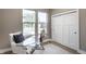 Modern home office featuring a glass desk, ample natural light, and a closet for storage at 43 N Walcott St, Indianapolis, IN 46201