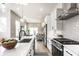 Modern kitchen with white countertops, stainless steel appliances, and an open design leading to living spaces at 43 N Walcott St, Indianapolis, IN 46201