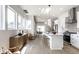 Bright, open kitchen featuring white cabinetry, a spacious island, and modern stainless steel appliances at 43 N Walcott St, Indianapolis, IN 46201
