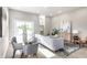 Bright living room featuring modern decor, light hardwood floors, and a glass dining table at 43 N Walcott St, Indianapolis, IN 46201