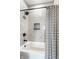 Shower and tub combo featuring gray tiles, black fixtures, and a striped curtain at 43 N Walcott St, Indianapolis, IN 46201