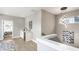 Staircase with modern chandelier, white banister, and open layout to other rooms at 43 N Walcott St, Indianapolis, IN 46201