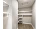 Spacious walk-in closet features custom shelving for optimal storage and organization; hardwood flooring at 43 N Walcott St, Indianapolis, IN 46201