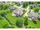 Aerial shot of a property highlighting its expansive lawn, outdoor deck area, and surrounding neighborhood at 4368 W Eagle Trce, New Palestine, IN 46163