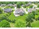 Aerial view of a suburban home with a well-maintained lawn, a wooden deck, and mature trees dotting the landscape at 4368 W Eagle Trce, New Palestine, IN 46163