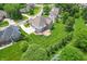 Bird's-eye view of a residential property featuring a large yard, inviting deck, and surrounding tree-lined streets at 4368 W Eagle Trce, New Palestine, IN 46163