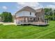 Exterior of a lovely home with a lush lawn, showcasing an expansive wooden deck for entertaining at 4368 W Eagle Trce, New Palestine, IN 46163