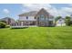 Large backyard featuring a well-kept lawn and an expansive raised deck at 4368 W Eagle Trce, New Palestine, IN 46163