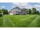 A spacious backyard with a well-maintained lawn and a raised wooden deck at 4368 W Eagle Trce, New Palestine, IN 46163