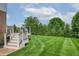 Beautiful backyard with a well-manicured lawn, mature trees, and a charming deck with stairs, ideal for relaxing at 4368 W Eagle Trce, New Palestine, IN 46163
