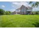 Expansive backyard featuring lush lawn and mature trees with a deck connected to the house at 4368 W Eagle Trce, New Palestine, IN 46163