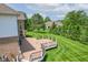 Picture of a spacious wooden deck overlooking a lush green backyard with mature trees and professional landscaping at 4368 W Eagle Trce, New Palestine, IN 46163