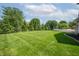 Expansive backyard featuring a lush lawn, mature trees, and a well-maintained deck, perfect for outdoor enjoyment at 4368 W Eagle Trce, New Palestine, IN 46163