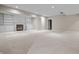 A finished basement with neutral carpet, fireplace and built-in shelving under recessed lighting at 4368 W Eagle Trce, New Palestine, IN 46163