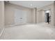 Finished basement with neutral carpet and an arched doorway next to a double door closet at 4368 W Eagle Trce, New Palestine, IN 46163
