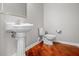 This bathroom features a white sink and toilet set against a backdrop of hardwood floors at 4368 W Eagle Trce, New Palestine, IN 46163
