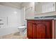 Bathroom featuring a bath tub with white tile surround and dark wood vanity at 4368 W Eagle Trce, New Palestine, IN 46163