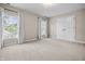 A bright bedroom with neutral carpet, two windows, and a double door closet at 4368 W Eagle Trce, New Palestine, IN 46163