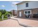Spacious wooden deck featuring a grill, with access to the house and a view of the landscaped backyard at 4368 W Eagle Trce, New Palestine, IN 46163