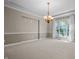Formal dining room features a modern chandelier and bright windows at 4368 W Eagle Trce, New Palestine, IN 46163