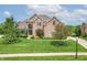 Stately brick home with manicured lawn, mature trees, and a circular driveway leading to the main entrance at 4368 W Eagle Trce, New Palestine, IN 46163