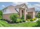 Charming brick home with lush landscaping, featuring various trees and decorative shrubbery at 4368 W Eagle Trce, New Palestine, IN 46163