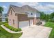Spacious home featuring a three-car garage and a concrete driveway at 4368 W Eagle Trce, New Palestine, IN 46163
