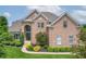 Elegant brick home with a grand entrance, symmetrical design, and beautifully landscaped front yard at 4368 W Eagle Trce, New Palestine, IN 46163