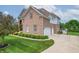 A brick house with a three-car garage and landscaped front yard, presenting a welcoming and well-maintained exterior at 4368 W Eagle Trce, New Palestine, IN 46163