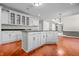 Bright kitchen boasts white cabinets, granite countertops, and hardwood floors at 4368 W Eagle Trce, New Palestine, IN 46163