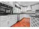 Modern kitchen with white cabinets, granite countertops, and stainless steel appliances at 4368 W Eagle Trce, New Palestine, IN 46163