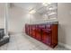 Elegant bathroom featuring double sinks with a large vanity, and tiled floor with access to jacuzzi at 4368 W Eagle Trce, New Palestine, IN 46163