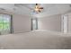Expansive main bedroom with tray ceiling, ceiling fan and large windows offering natural light at 4368 W Eagle Trce, New Palestine, IN 46163