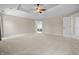 Spacious main bedroom with tray ceiling, ceiling fan and open doorway leading to the bath at 4368 W Eagle Trce, New Palestine, IN 46163