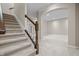 Carpeted staircase leading to a finished basement with an arched doorway at 4368 W Eagle Trce, New Palestine, IN 46163